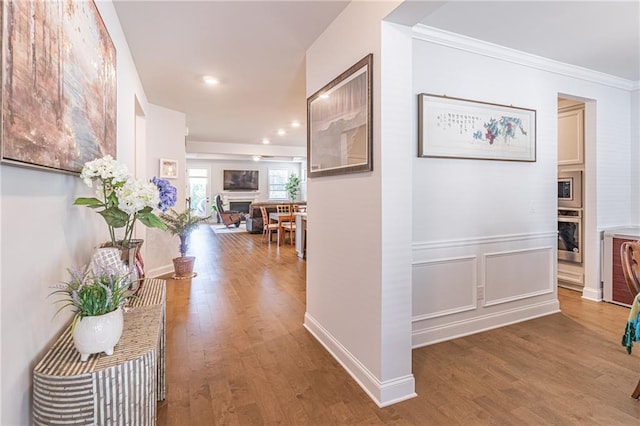 corridor featuring hardwood / wood-style floors and ornamental molding