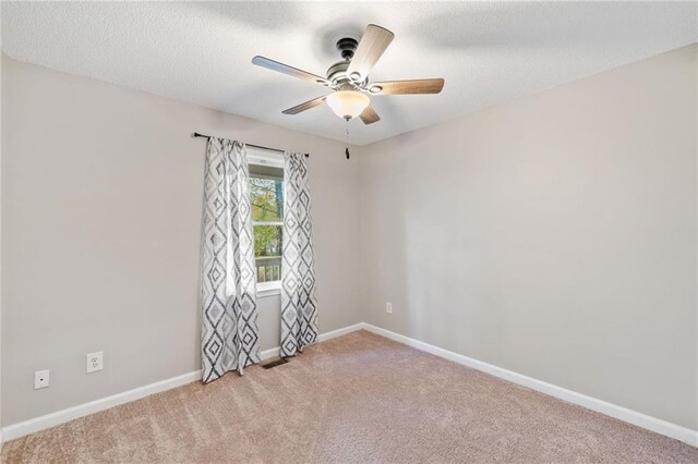 unfurnished bedroom featuring ceiling fan and light carpet