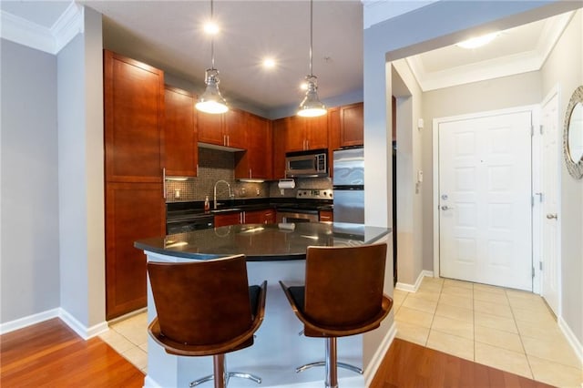 kitchen featuring stainless steel appliances, a kitchen island, and light tile patterned floors