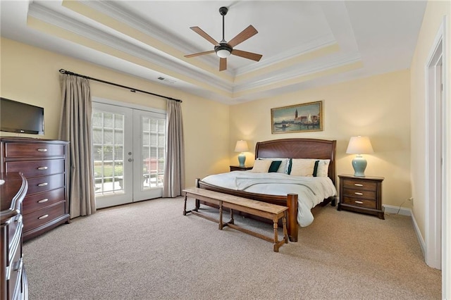 bedroom with ornamental molding, french doors, a tray ceiling, light colored carpet, and access to outside