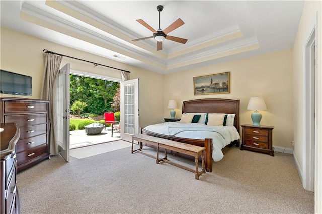 bedroom with a raised ceiling, access to outside, ornamental molding, light carpet, and ceiling fan