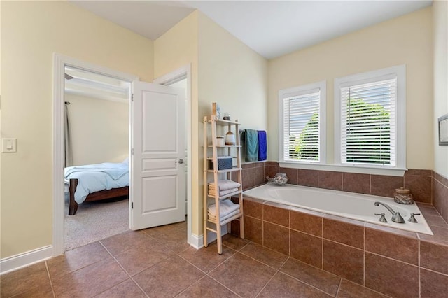 bathroom with a garden tub, tile patterned floors, and ensuite bathroom