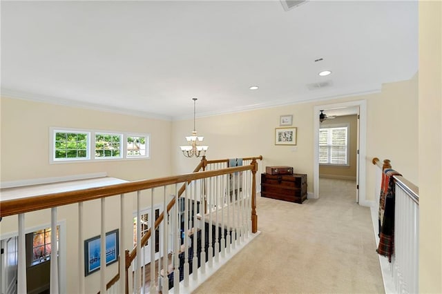 hallway featuring a chandelier, carpet, an upstairs landing, ornamental molding, and baseboards