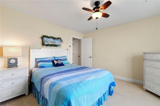 bedroom with light carpet, baseboards, and a ceiling fan