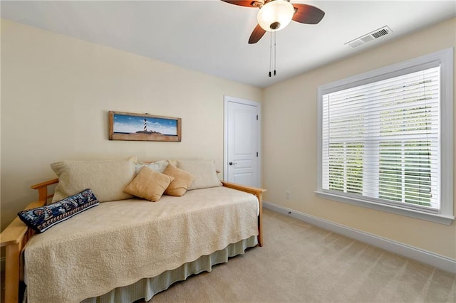 bedroom with baseboards, light carpet, and ceiling fan