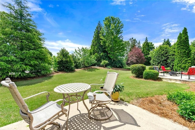 view of patio featuring view of wooded area