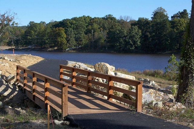 dock featuring a forest view and a water view