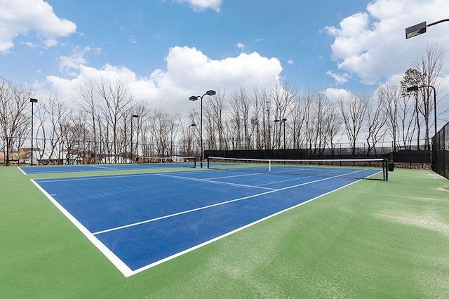 view of tennis court with fence and community basketball court