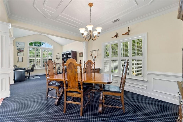 carpeted dining room with a chandelier, ornamental molding, decorative columns, a wainscoted wall, and lofted ceiling