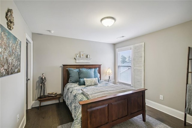 bedroom with dark hardwood / wood-style floors