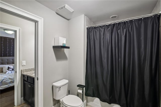 bathroom featuring vanity, hardwood / wood-style flooring, and toilet