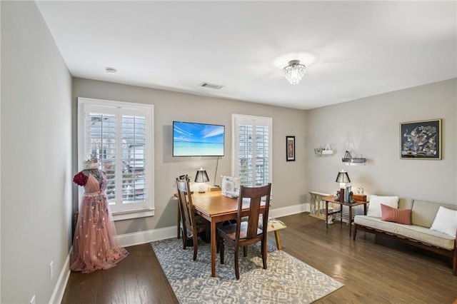 dining area with dark hardwood / wood-style floors