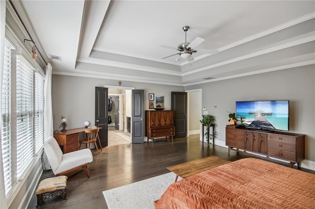 bedroom featuring ornamental molding, wood-type flooring, a tray ceiling, and ceiling fan