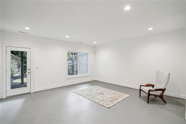 unfurnished room with concrete floors