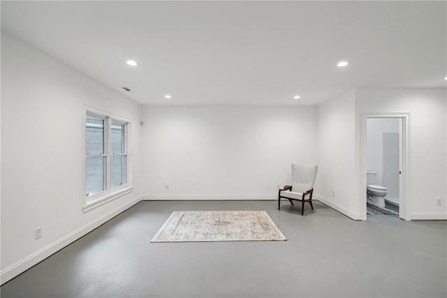 unfurnished room featuring concrete floors