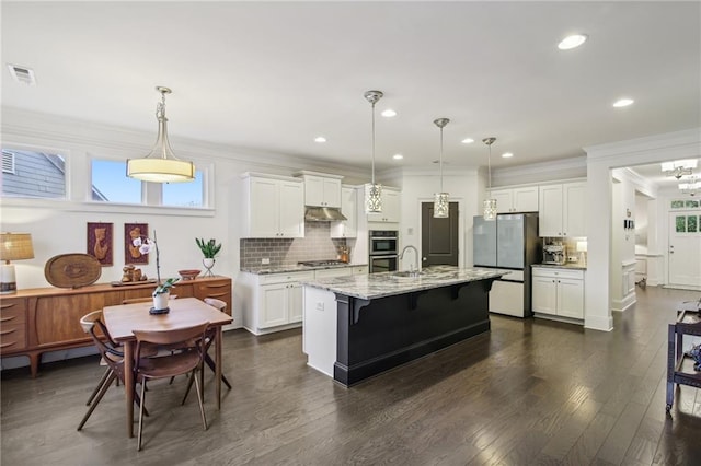 kitchen featuring white cabinets, a healthy amount of sunlight, and stainless steel appliances