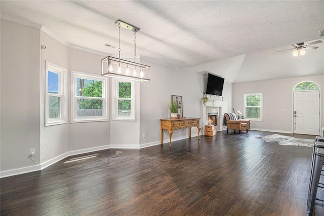 232 Christian Cir, Carrollton, GA 30116 - living area with wood finished floors, a warm lit fireplace, ceiling fan, baseboards, and a textured ceiling