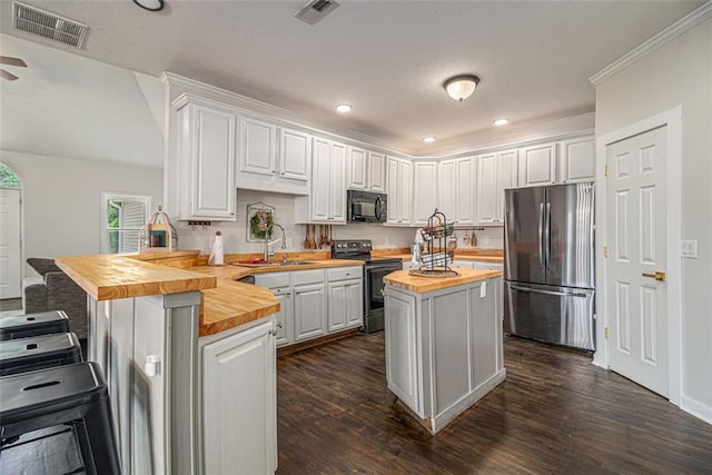 232 Christian Cir, Carrollton, GA 30116 - kitchen featuring wood counters, freestanding refrigerator, range with electric cooktop, black microwave, and a peninsula