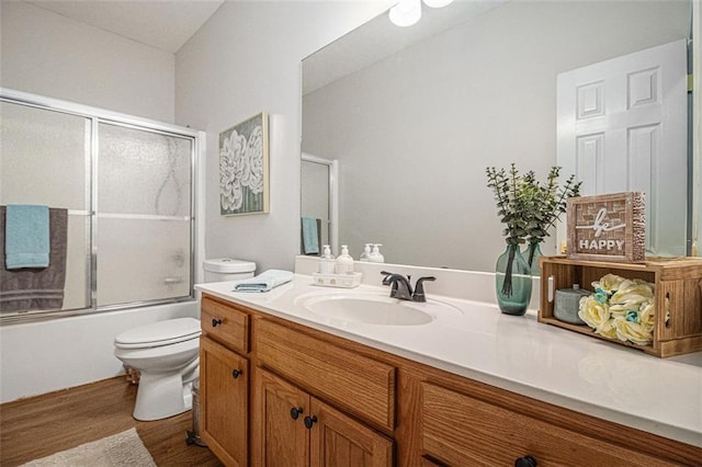232 Christian Cir, Carrollton, GA 30116 - bathroom with toilet, wood finished floors, vanity, and combined bath / shower with glass door