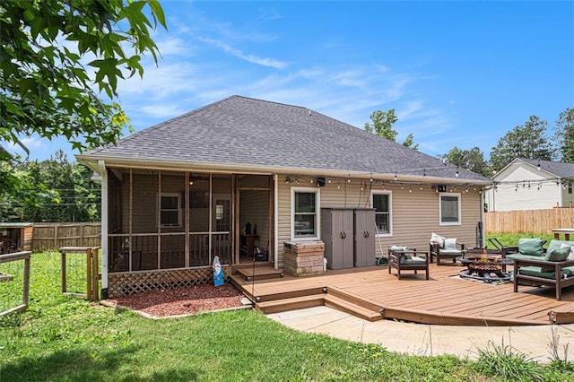 232 Christian Cir, Carrollton, GA 30116 - back of property with an outdoor fire pit, roof with shingles, a deck, and a sunroom