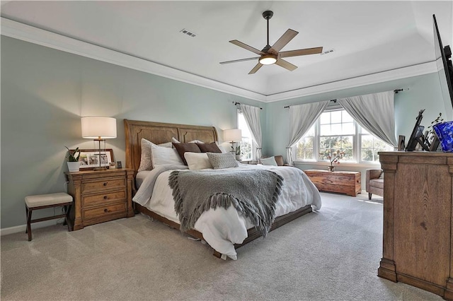 carpeted bedroom featuring ceiling fan and crown molding