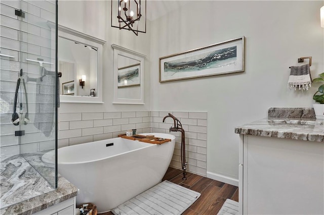 bathroom with a washtub and vanity