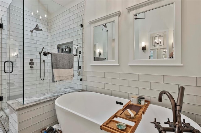 bathroom with a chandelier, tile walls, and independent shower and bath