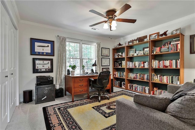 home office with light carpet, ceiling fan, and crown molding