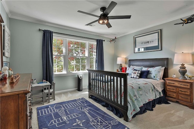 bedroom with ceiling fan, light colored carpet, and crown molding