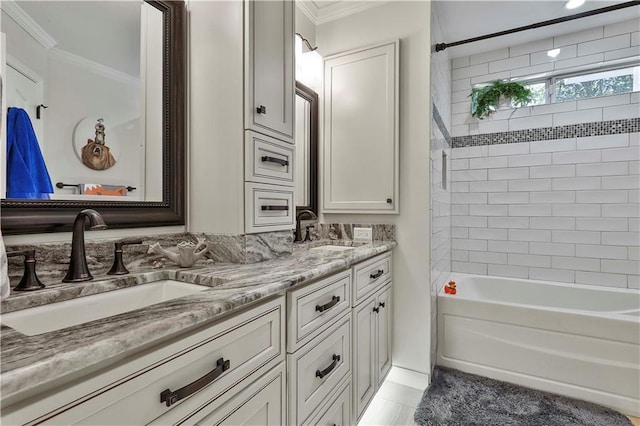 bathroom with crown molding, tiled shower / bath combo, and vanity