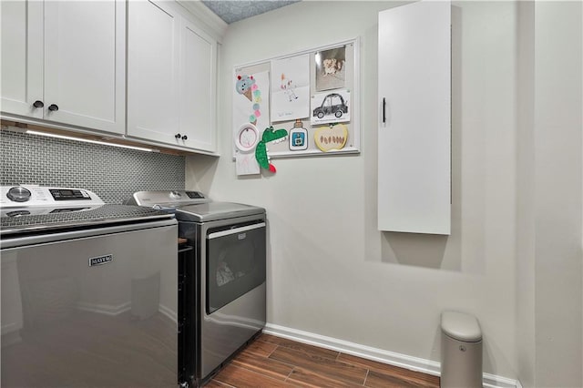 washroom featuring cabinets and washing machine and clothes dryer