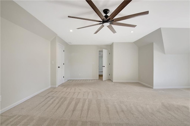 spare room with ceiling fan, light carpet, and lofted ceiling