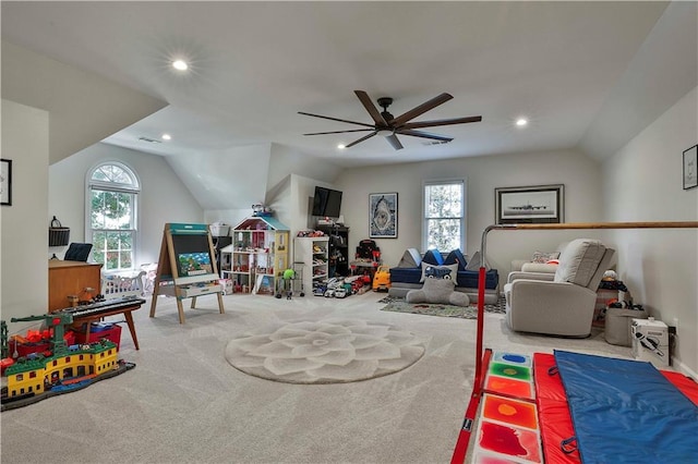 recreation room featuring vaulted ceiling, plenty of natural light, and carpet flooring