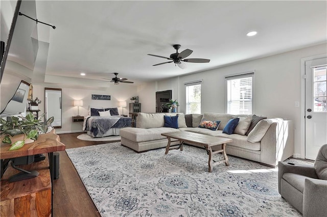 living room featuring ceiling fan and light hardwood / wood-style flooring