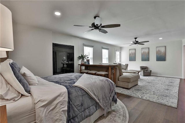 bedroom featuring ceiling fan and dark hardwood / wood-style floors