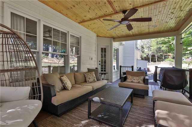 sunroom / solarium with wooden ceiling and ceiling fan