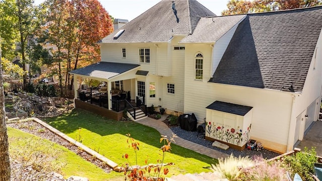 rear view of house with a yard