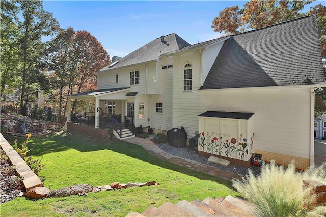 back of property featuring a lawn and a porch