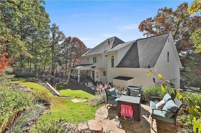 back of property with a lawn, an outdoor hangout area, and a patio