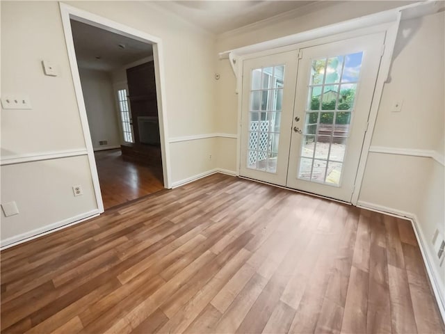 doorway to outside featuring french doors, crown molding, and light hardwood / wood-style flooring