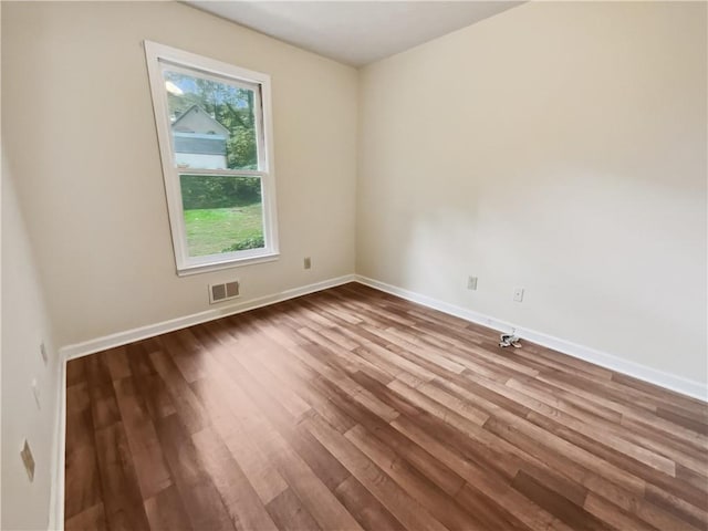 unfurnished room featuring wood-type flooring