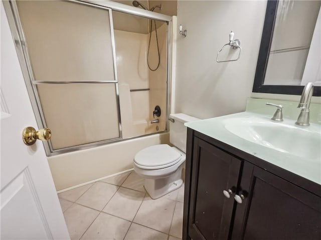 full bathroom featuring toilet, vanity, tile patterned flooring, and shower / bath combination with glass door