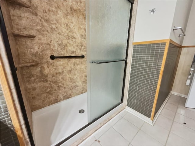 bathroom featuring an enclosed shower and tile patterned flooring