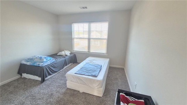 bedroom featuring carpet floors, baseboards, and visible vents