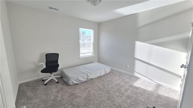 unfurnished bedroom with carpet floors, visible vents, and baseboards