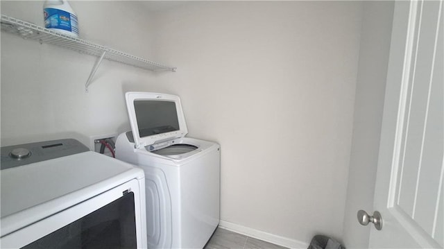 laundry area with laundry area, baseboards, and independent washer and dryer