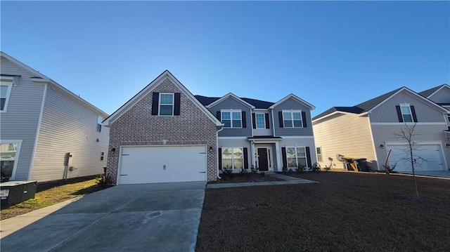 traditional-style home with a garage, concrete driveway, brick siding, and a front yard