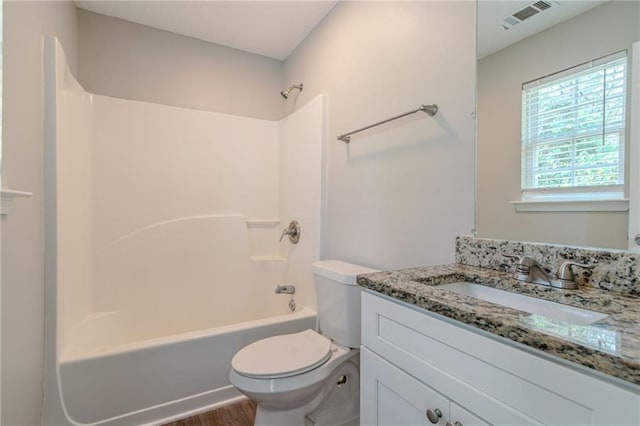 full bathroom with hardwood / wood-style flooring, vanity, shower / bathing tub combination, and toilet