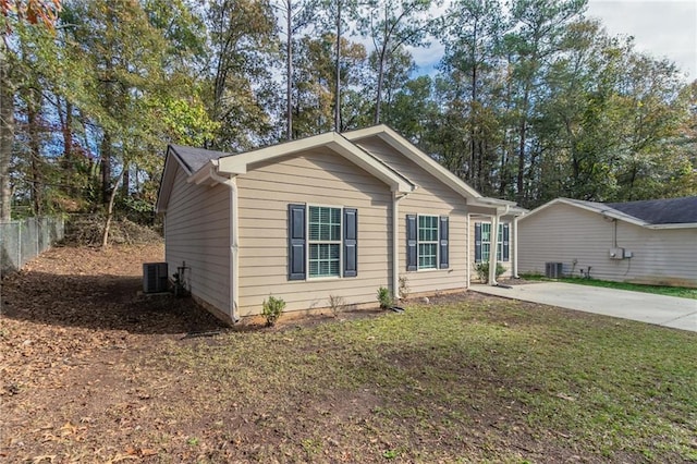 view of front of house featuring a front lawn and central air condition unit