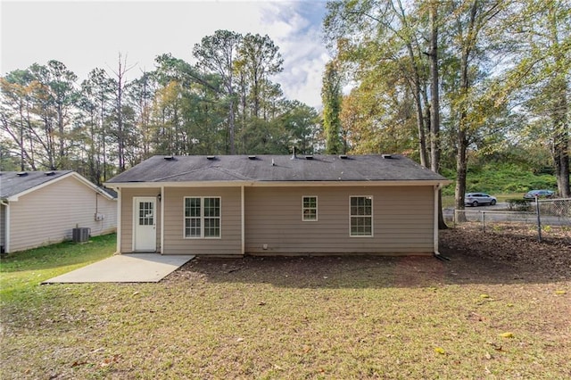 back of house featuring cooling unit, a patio, and a lawn